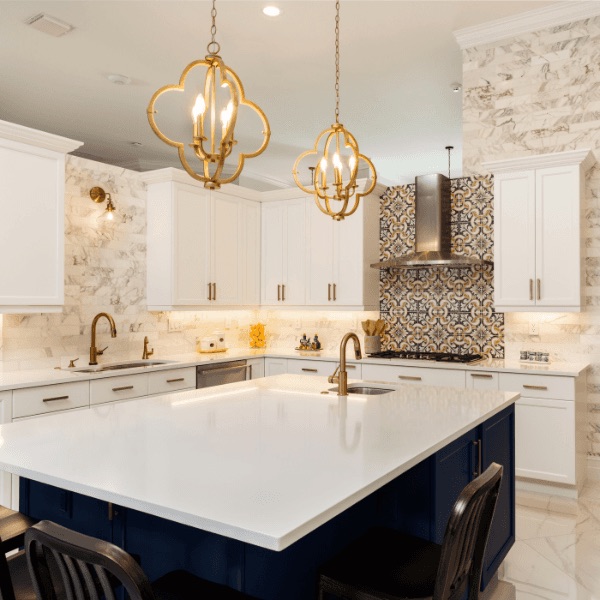 Custom kitchen remodel with navy island, quartz counters, and brass pendant lights
